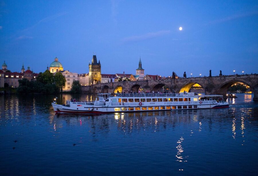 Prague: City Tour and Dinner Cruise with Hotel Pickup - Boarding the boat on the Vltava