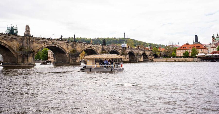 Prague: Party Tiki Boat Sightseeing Cruise with Drinks - Boarding between two river landmarks